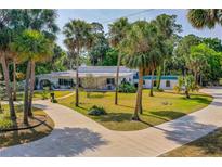 Expansive, charming home with mature landscaping, circular driveway, and unique architectural accents throughout at 1159 Magnolia Ave, Daytona Beach, FL 32114