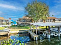 Waterfront condo featuring a boat dock and lift, perfect for enjoying lake living and recreational water activities at 1640 Juno Trl # 105D, Astor, FL 32102