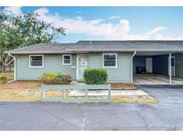 Charming single-story home with light green siding, covered parking, and manicured front bushes at 244 Oakleigh Dr # 200, Deland, FL 32724