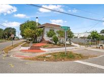 Charming corner lot home featuring unique brick steps and mature landscaping at 401 N Oleander Ave, Daytona Beach, FL 32118