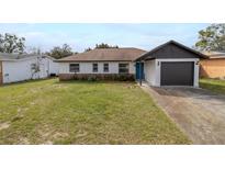Charming one-story home with a well-maintained front yard and a one car garage at 1744 Valencia Ave, Ormond Beach, FL 32174