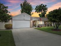 Charming single-story home with a well-maintained lawn, attached garage, and inviting curb appeal at 934 Tall Pine Dr, Port Orange, FL 32127