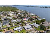Waterfront home with easy access to the river and ocean, showcasing mature landscaping and neighborhood charm at 136 Reef Rd, South Daytona, FL 32119