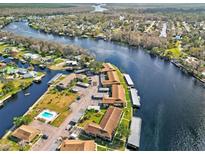 Panoramic aerial view of waterfront property with pool, boat docks, and stunning river views at 1640 Juno Trl # 202E, Astor, FL 32102