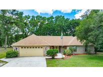 Charming one-story brick home featuring a well-manicured lawn and an attached two-car garage at 2270 Wilmhurst Rd, Deland, FL 32720
