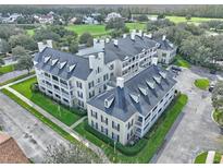 Stunning aerial view of multi-Gathering home featuring lush landscaping and a large parking lot at 280 Celebration Blvd # 203, Kissimmee, FL 34747