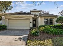 Charming single-story home featuring an attached two-car garage and well-maintained front yard at 902 Heron Point Cir, Deland, FL 32724