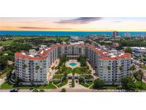 Stunning aerial view of a resort complex with a pool, lush landscaping, and the ocean in the background at 1 John Anderson Dr # 2180, Ormond Beach, FL 32176