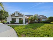 Charming single-story home with well-manicured lawn, mature landscaping, and inviting entrance at 101 Green Heron Ct, Daytona Beach, FL 32119