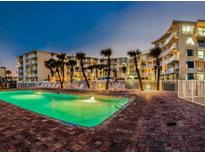 Inviting pool area at dusk with palm trees and stylish condo buildings in the background at 1233 S Atlantic Ave # 3070, Daytona Beach, FL 32118