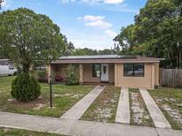 Charming single-story home featuring desert landscaping, solar panels, and a lengthy driveway at 1333 E Lombardy Dr, Deltona, FL 32725