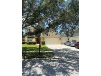Charming two-story home with a well-manicured lawn, mature tree, and three-car garage at 3660 Daydream Pl, St Cloud, FL 34772