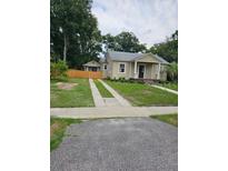 Charming single-story home featuring a welcoming front porch and a well-maintained lawn at 441 N Kentucky Ave, Deland, FL 32724