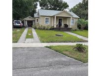 Charming single-story home with a well-manicured lawn, driveway and inviting front porch at 441 N Kentucky Ave, Deland, FL 32724