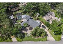 Stunning aerial view of a large home with lush landscaping, a pool, and water access at 1108 Shockney Dr, Ormond Beach, FL 32174