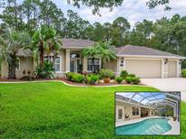 Inviting home featuring a well-manicured lawn, lush landscaping, and a screened pool area perfect for relaxation at 1254 Royal Pointe Ln, Ormond Beach, FL 32174