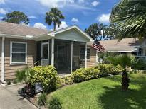 Charming home featuring a screened front porch and well-maintained landscaping at 1218 Daytona Ave, Daytona Beach, FL 32117