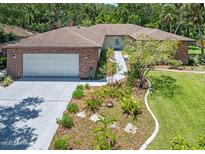 Beautiful single story brick home featuring a large driveway and manicured lawn at 1108 Northside Dr, Ormond Beach, FL 32174