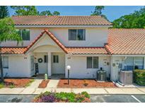 Charming two-story townhome featuring a red tile roof and welcoming front porch at 3522 Forest Branch Dr # D, Port Orange, FL 32129