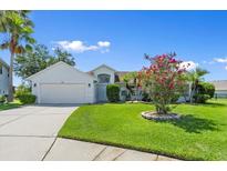 Charming single-story home boasting a well-manicured lawn and attached two-car garage at 1904 Rouzbeh Ct, Port Orange, FL 32128