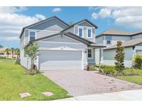 Charming two-story home with a large two-car garage and well-manicured landscaping at 288 Links Terrace Blvd, Daytona Beach, FL 32124