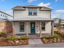 Two-story home with a covered front porch and landscaped yard at 10185 Pearson Ave, Orlando, FL 32827