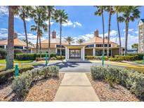 Community clubhouse with palm trees and circular drive at 4624 Harbour Village Bv # 4205, Ponce Inlet, FL 32127