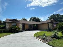 One-story house with stone accents and a curved driveway at 213 Stevenage Dr, Longwood, FL 32779