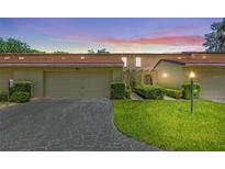 Charming one-story townhouse featuring an attached garage and manicured lawn at 1111 Lakeshore Dr # A3, Eustis, FL 32726