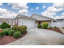 Charming home with a well-maintained lawn, beautiful landscaping, and a cozy two-car garage at 3114 Jemima Ave, The Villages, FL 32163