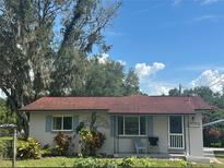 Charming single-story home with a well-manicured lawn and a cozy front porch entry at 11635 Se Highway 42, Weirsdale, FL 32195