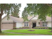 Beautiful one-story home with a two-car garage and lush landscaping at 2360 Park Forest Blvd, Mount Dora, FL 32757