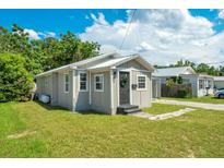 Charming single-story home with a well-maintained lawn and a neutral-toned exterior at 622 N Disston Ave, Tavares, FL 32778