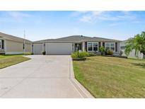 Single-story house with a two-car garage and well-manicured lawn at 736 Jones Ln, The Villages, FL 32163