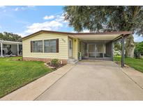 Charming single-Gathering home featuring a well-maintained lawn and screened carport for added convenience at 1605 W Schwartz Blvd, The Villages, FL 32159
