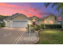 Beautiful two-story home with a two-car garage and landscaped yard at 1828 Treadwell Ter, The Villages, FL 32162