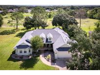 One-story house with a large yard and golf course view at 557 Dowling Cir, Lady Lake, FL 32159