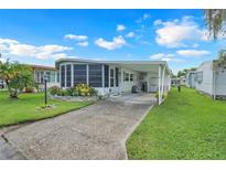 Charming mobile home with well-maintained lawn and covered carport, providing comfortable and convenient living at 1401 W Highway 50 # 12, Clermont, FL 34711