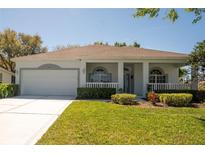 Charming single-story home with a well-manicured lawn and inviting front porch at 2075 Grafton Ave, Clermont, FL 34711