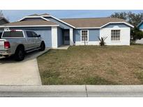 Well-maintained single-story home with a gray truck parked in the driveway at 3726 Imperial Dr, Winter Haven, FL 33880