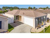 Attractive single-story home with a two-car garage and landscaped yard at 547 Richburg St, The Villages, FL 32162