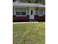 Charming single-story home with a brick facade and well-maintained lawn at 620 Gould St, Eustis, FL 32726