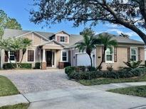 Beautiful one-story home with a brick driveway, a two-car garage and well-maintained landscaping at 210 Westcott Ct, Deland, FL 32724