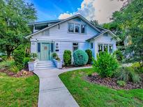 Charming two-story home with a well-manicured lawn and a light green door at 351 W 10Th Ave, Mount Dora, FL 32757