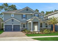 Beautiful two-story home featuring a two-car garage, landscaped yard, and a welcoming covered entry at 14255 Crest Palm Ave, Windermere, FL 34786