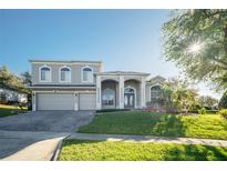 Two-story house with a three-car garage and landscaped lawn at 1148 Calloway Cir, Clermont, FL 34711