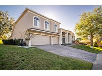 Two-story house with a large driveway and landscaped lawn at 1148 Calloway Cir, Clermont, FL 34711