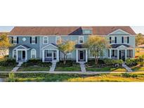 Charming townhomes feature colorful exteriors, inviting front porches and lush landscaping, creating a welcoming community atmosphere at 561 Juniper Springs Dr, Groveland, FL 34736