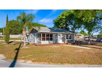 Charming single-story home with gray siding, front porch, and well-maintained landscaping at 13619 Lake Blvd, Winter Garden, FL 34787