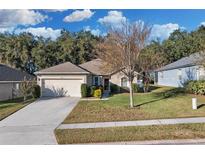 Charming single-story home featuring a well-manicured lawn and an attached two-car garage at 2354 Valhalla Dr, Tavares, FL 32778